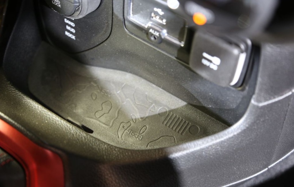 Just above the gear shifter on this vehicle is a topographical map of a Jeeps natural habitat